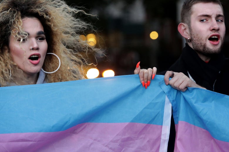 Protestors hold up the flag for Transgender and Gender Noncomforming people at a rally for LGBTQ rights at Washington Square Park on October 21, 2018 in New York City.